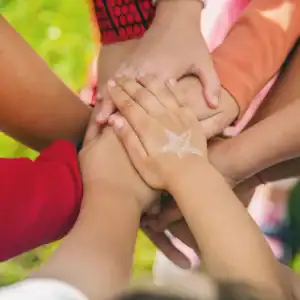 Children's hands united in a group gesture, symbolizing protection of children's rights