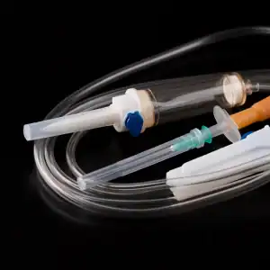 Medical device components including IV line and syringe, illustrating defective medical products