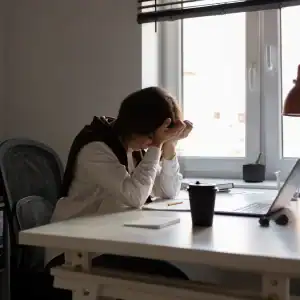 Employee experiencing stress and burnout while working remotely