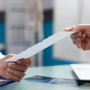 Close-up of employment contract or severance agreement being handed over