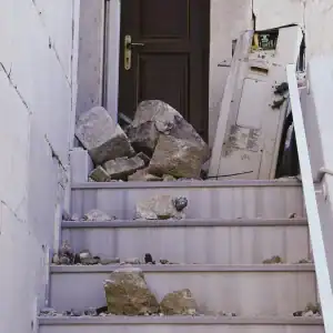Construction site with broken pavement and scattered equipment showing safety violations