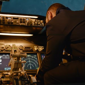 Pilot inside cockpit operating flight controls during a private flight