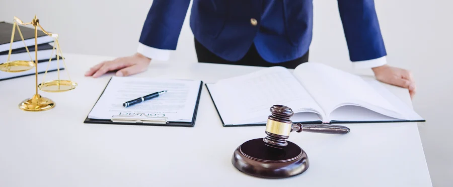 lawyer at a desk with office supplies and a contract