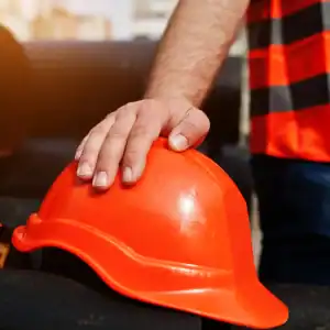 Union worker holding safety helmet during construction job