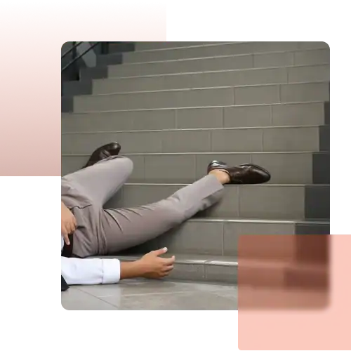 injury fall lawyer Man in formal attire lying on tiled stairs after a fall, representing a slip and fall accident