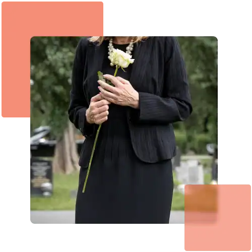 wrongful death: Woman dressed in black holding a white rose at a cemetery, symbolizing mourning after a wrongful death